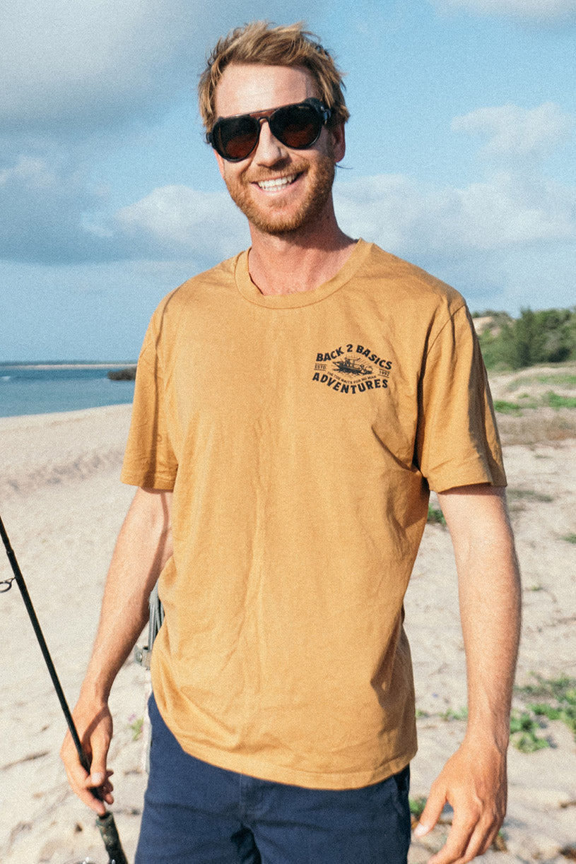 strick wearing the back 2 basics tee in rust while going fishing 