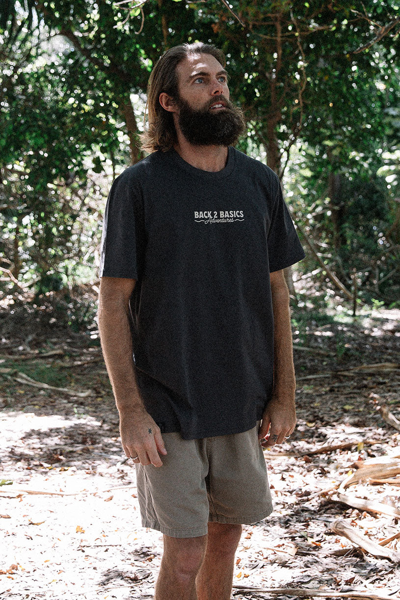 walking through the forest in the B2B Core Tee in classic charcoal