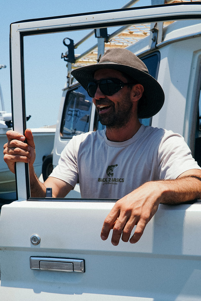 back 2 basics beige tee shirt with barramundi on the front